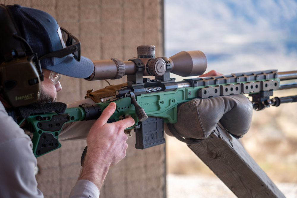 A precision rifle shooter using an XLR Envy Pro chassis during an off-season competition shooting match for hunters.